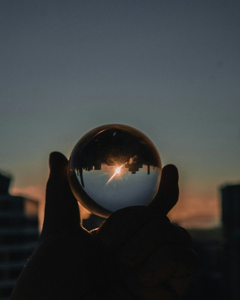 Cityscape shot through glass sphere representing millennial life.
